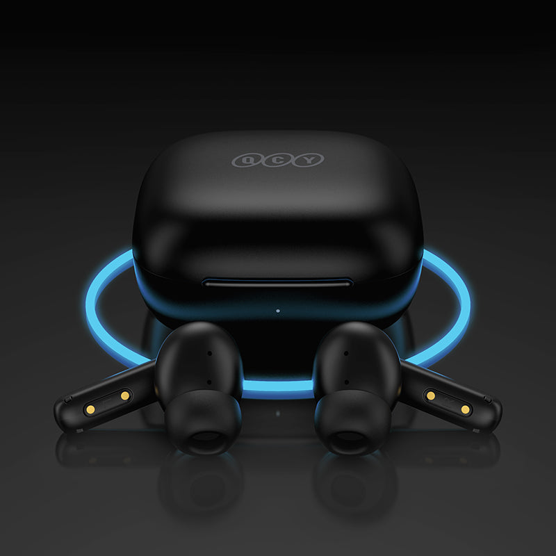 Black QCY T13 ANC with charging case on wireless charger, earbuds positioned beside, glowing blue light indicating charging